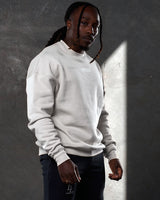 Right side view of men’s oversized crewneck in sand (off-white) with ultra-soft fleece, ribbed cuffs, and a relaxed, comfortable fit.