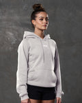 Right side view of white sand hoodie showing kangaroo pocket and tonal drawstrings.