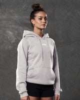 Right side view of white sand hoodie showing kangaroo pocket and tonal drawstrings.