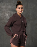 Right side view of women’s dark brown hoodie with tonal drawstrings and fitted sleeves.