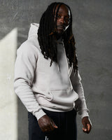 Right side view of LYFTLYFE hoodie in white sand showing sleeve fit and minimal branding.