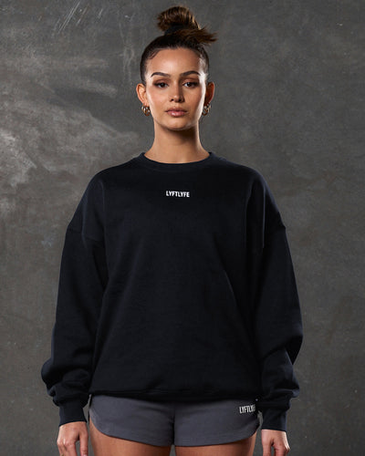 Black sweatshirt with 'LYFLYFE' logo on a light gray background