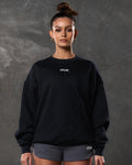 Women’s oversized black crewneck sweater with ultra-plush fleece, 3D rubberized Lyftlyfe logo, and ribbed cuffs and hem.