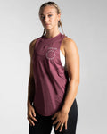 Women’s sleeveless gym tank top in prune shown from the left side, highlighting its lightweight mesh panels and moisture-wicking properties.