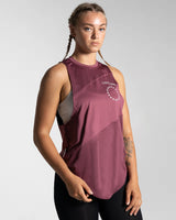 Women’s sleeveless gym tank top in prune shown from the right side, highlighting its lightweight mesh panels and moisture-wicking properties.