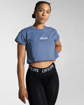 Right side view of the blue Drill Women’s Crop T-shirt, showcasing its fitted cut, soft-stretch fabric, and moisture-wicking properties.