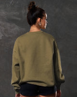 Women’s oversized green crewneck sweater, shown from the back side, with plush fabric and ribbed detailing for casual wear.