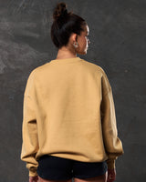 Women’s yellow oversized fleece crewneck, back view featuring ribbed hem, soft-touch fabric, and durable construction.