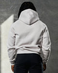 Rear angle of LYFTLYFE Elite hoodie in white sand showing fitted hem and relaxed hood.