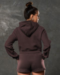 Rear angle of dark brown Elite cropped hoodie showing hood and mid-length cut.