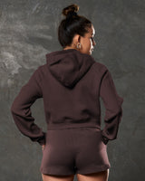 Rear angle of dark brown Elite cropped hoodie showing hood and mid-length cut.