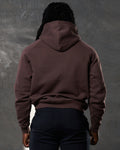 Back view of brown men's hoodie with hood up and no visible branding.