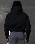 Black men's hoodie back detail with plush finish and dropped shoulder design.