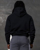 Black men's hoodie back detail with plush finish and dropped shoulder design.