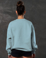 Women’s light blue Adapt Crew, back view showcasing breathable fleece fabric and clean ribbed detailing.