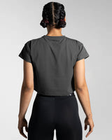 Back view of Drill Women’s Crop T-shirt in dark grey, showcasing its fitted cut, soft-stretch fabric, and moisture-wicking properties.