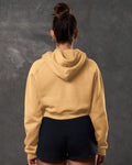 Yellow hoodie from the back with classic drop-shoulder and crop hem.