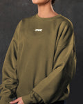 Detailed shot of women’s Adapt Crew in green showcasing Lyftlyfe branding, ultra-soft fleece fabric, and ribbed detailing.