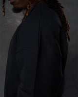 Side view of the men’s black Adapt Crew, highlighting clean stitching details and ultra-plush fleece material.