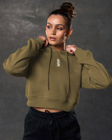 Close-up of white LYFTLYFE logo on chest of green cropped hoodie.