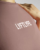 Close-up of Lyftlyfe’s textured 3D logo on the Contour Oversized Tee in rose color, designed for a premium aesthetic.