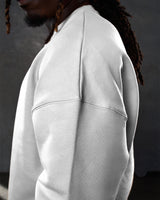 Detailed side view of the Adapt Crew in sand (off-white), featuring durable stitching and soft-touch cotton-polyester material.