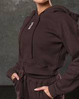 Detail shot of Elite hoodie logo and fabric texture on brown fleece.