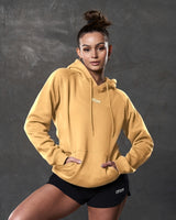 Women's elite hoodie in yellow styled with black gym shorts.