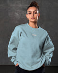 Women’s ultra-soft light blue crewneck sweater with lightweight fleece fabric, ribbed details, and Lyftlyfe logo.