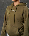Close up of LYFTLYFE logo on front chest of green women’s hoodie.