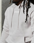 Close-up of LYFTLYFE logo on chest and tonal drawstrings of white sand hoodie.