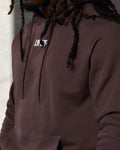 Close-up of LYFTLYFE logo on chest and tonal drawstrings of brown hoodie.