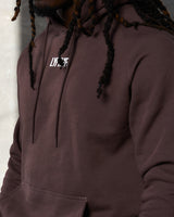 Close-up of LYFTLYFE logo on chest and tonal drawstrings of brown hoodie.