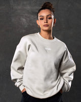 Women’s sand (off-white) Adapt Crew featuring a relaxed oversized fit, centered Lyftlyfe chest logo, and soft fleece fabric.