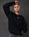 Women’s ultra-soft black crewneck sweater with lightweight fleece fabric, ribbed details, and Lyftlyfe logo.
