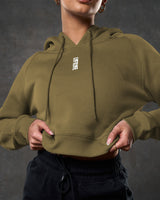 Close-up of LYFTLYFE 3D rubberized logo on chest of green cropped hoodie.