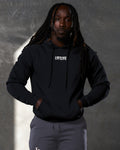 Relaxed pose featuring Elite hoodie in black with bold chest branding.