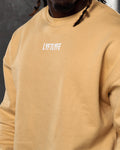 Detailed view of Lyftlyfe branding and ultra-soft fleece fabric on men’s yellow Adapt Crew.