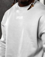 Detailed shot of men’s Adapt Crewneck in sand (off-white) featuring ultra-soft fleece and Lyftlyfe’s signature 3D logo on the chest.