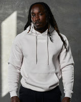 Front shot of men's Elite hoodie in white sand, featuring plush fleece and tonal drawstrings.