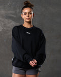 Women’s ultra-soft black crewneck sweater with lightweight fleece fabric, ribbed details, and a white Lyftlyfe logo on the chest. 