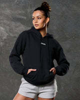 Front view with black LYFTLYFE hoodie and light grey training shorts.