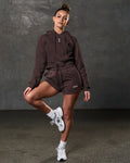 Full outfit view with fleece crop hoodie in brown and matching workout shorts.