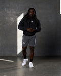 Lifestyle view of Elite hoodie outfit in black and grey from head to toe.