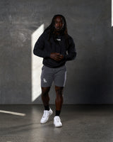 Lifestyle view of Elite hoodie outfit in black and grey from head to toe.