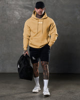 Lifestyle view of Elite hoodie outfit in yellow and black from head to toe.