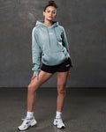 Full outfit view with LYFTLYFE hoodie in slate color and black training shorts.
