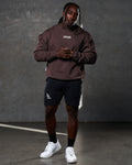 Men’s fleece crewneck in dark brown with a clean, oversized design, ribbed hems, and a rubberized Lyftlyfe chest logo.