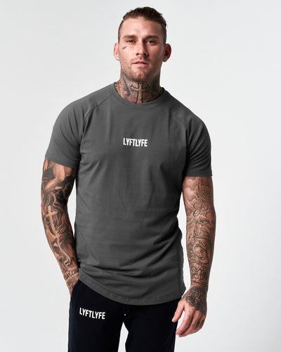 Charcoal grey LYFTLYFE contour t-shirt with white logo on light grey. 