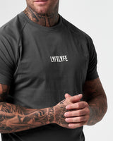 Close-up of the 3D rubberized LYFTLYFE logo on the chest of the Contour Men’s T-Shirt in dark grey, adding a premium touch.